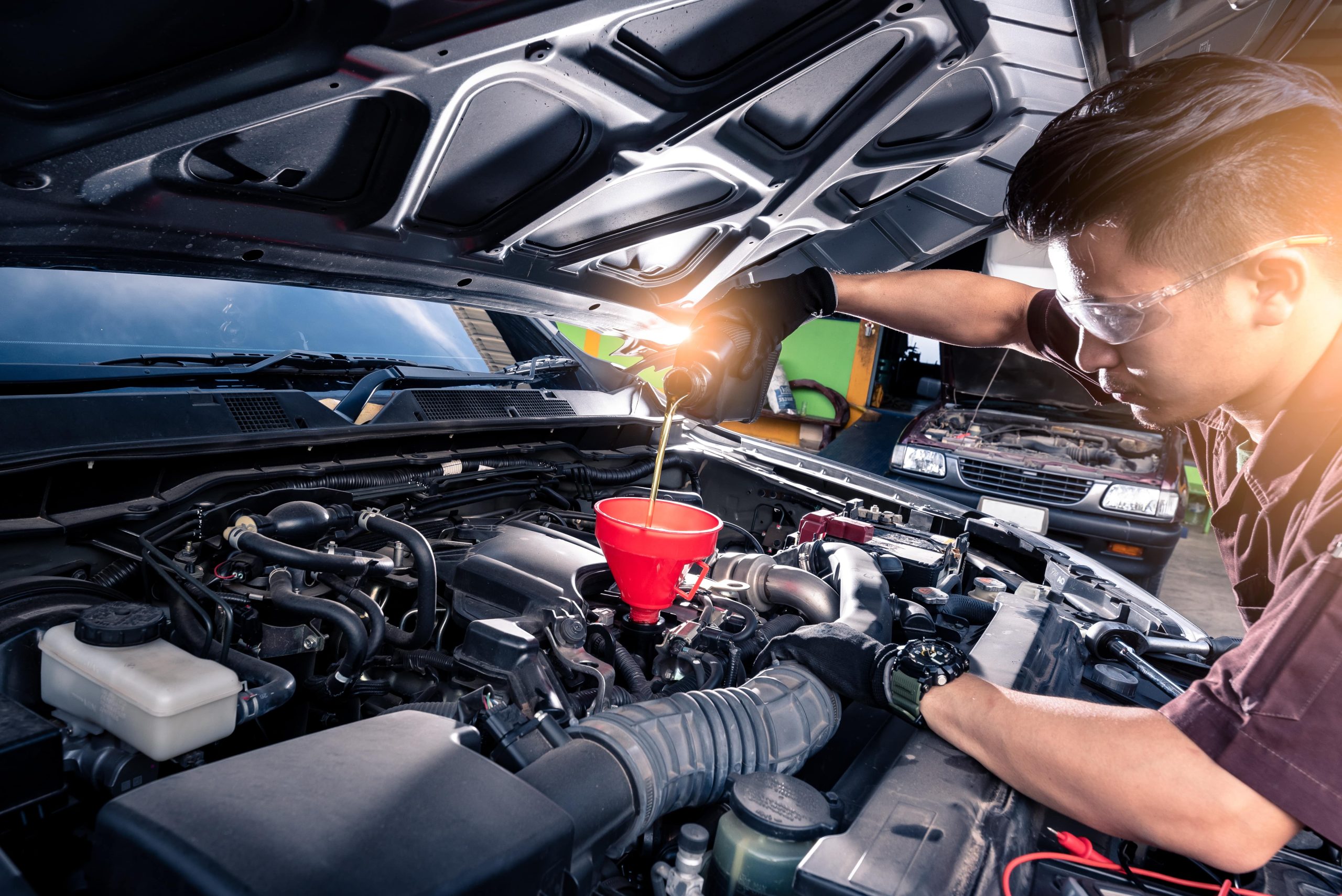 mechanic checking the oil in a car engine